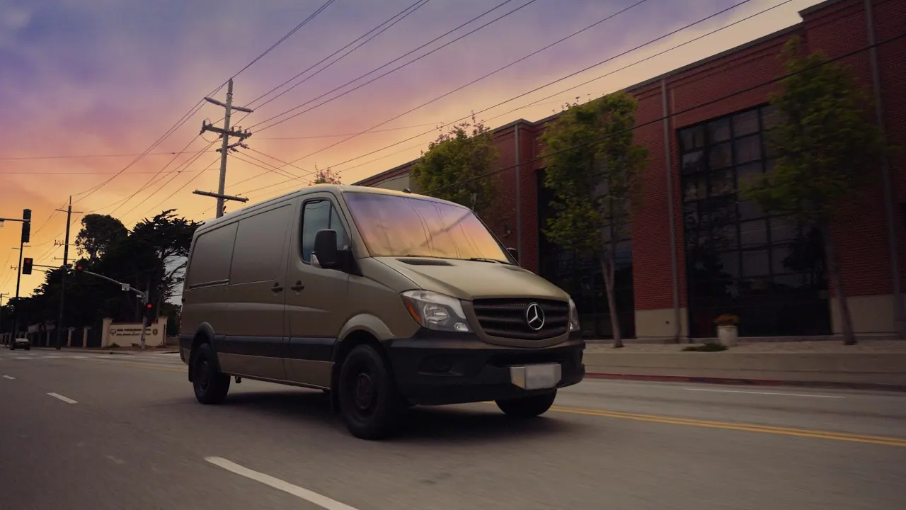 Marcos's Mercedes-Benz Sprinter camera van parked on a street at sunset