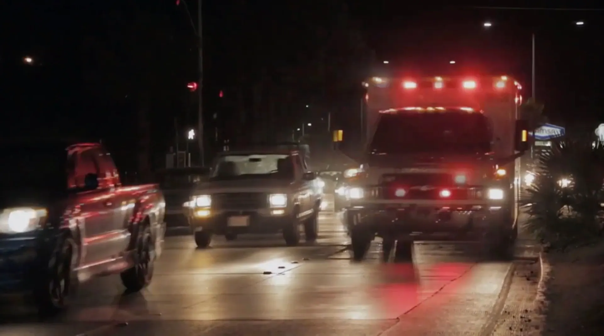 Ambulance with lights flashing on a street at night, from Killer at the Crime Scene