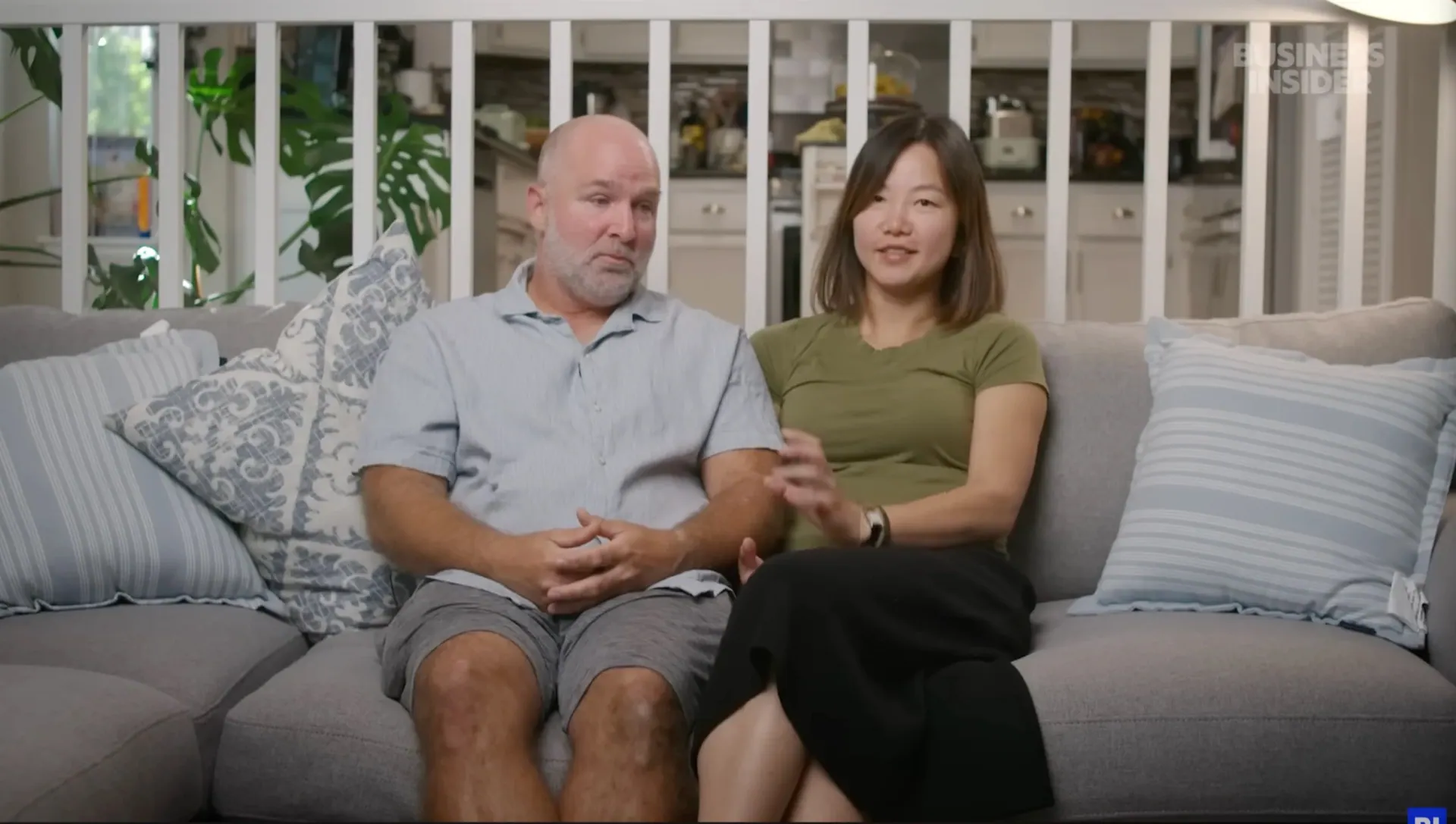 Couple interviewed on their sofa for Business Insider's Money Lessons